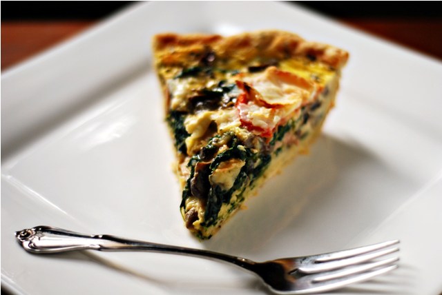 A slice of fully loaded quiche